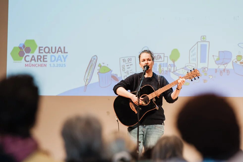 Katrin Freiburghaus beim Singen und mit einer Guitarre in der Hand